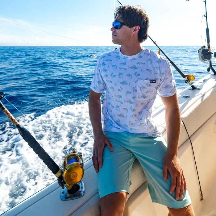 Ryder Devoe on a boat wearing Salt Life Mens Fish n Bones Performance Short Sleeve Tee SLX SLM6334 WHITE Front