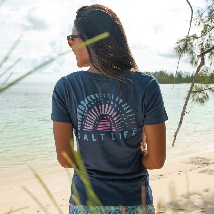 Stacey baker outside wearing Salt Life Rainbow Shell Ladies Tee SLJ10635 Washed Navy Back