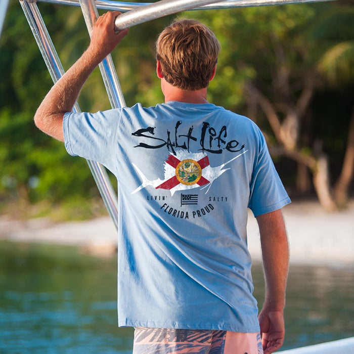 Man on a boat wearing Salt Life Florida Proud Hurricane Relief Tee SLM19041 Chambray