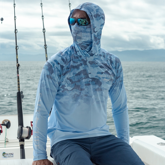 Ryder Devoe on boat wearing Salt Life Into the Abyss SLX Mens Hoodie SLM6240 Blue Front